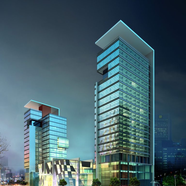 Modern skyscrapers with glass facades under evening lighting.
